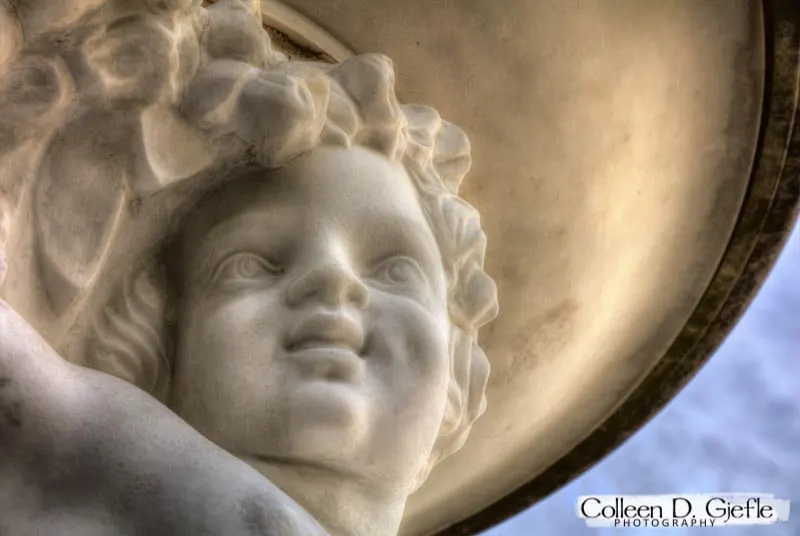 Closeup of a cherub statue face